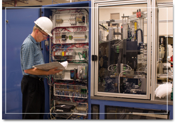 Electrician inspecting an industrial control panel